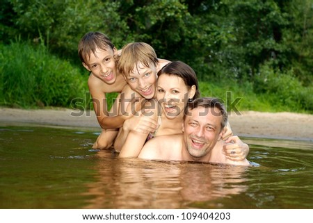 Happy family having fun in the company of each other on the river