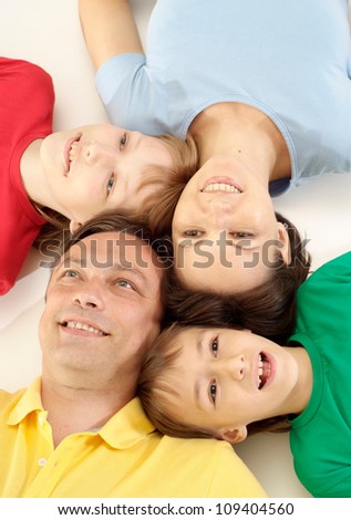 Good family in bright T-shirts have fun in the company of each other
