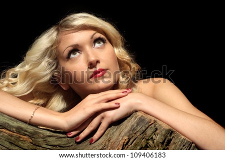 Nice blonde with a bright appearance on a black background