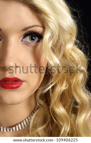 Flirtatious blonde with a bright appearance on a black background