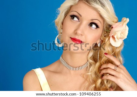 Flirtatious blonde with a bright appearance on a blue background