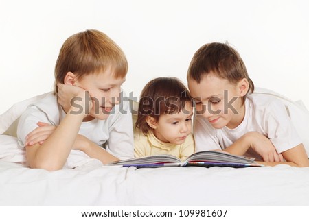 Funny children read a book at home