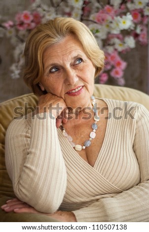 Beautiful older woman resting in the village after a hard working week