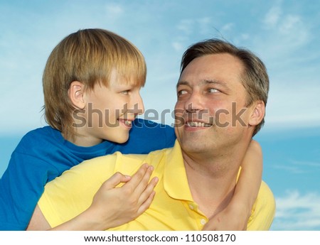 Happy family outdoors on blue sky background