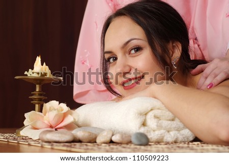 Caucasian lady lying on a massage in the spa salon