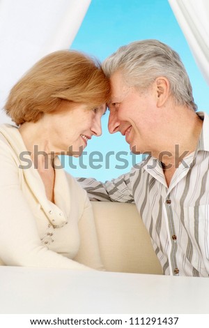 Beautiful older couple resting in the bedroom after a hard working week