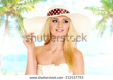 Pretty blonde with a bright appearance is resting at a resort
