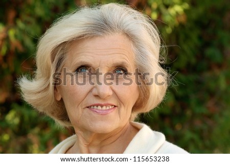 portrait of a nice old lady in the autumn park