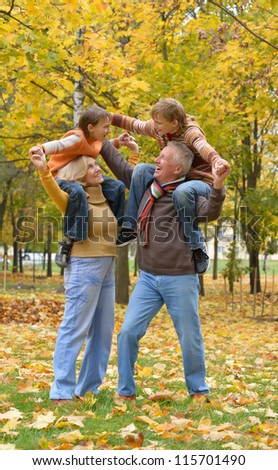 portrait of happy elderly couple and children rest fall