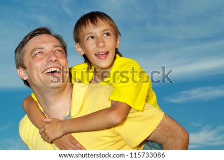 Nice family outdoors on blue sky background