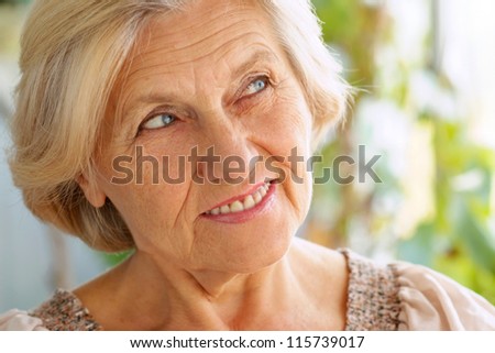 portrait of a nice older woman on a summer background