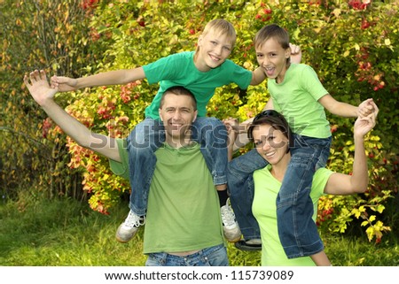 happy parents and children play in the park