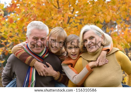 happy elderly couple and grandchildren together resting