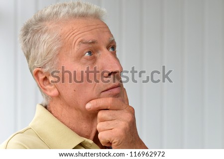 cute old man poses in a room