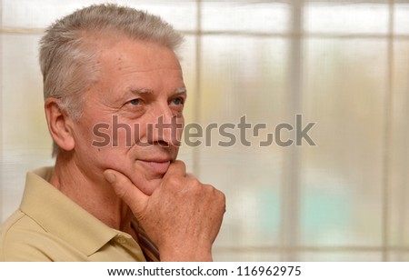 nice older man poses in a room