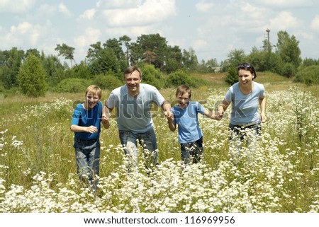 happy family in the blue in a summer park