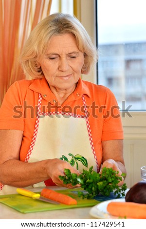 elderly woman preparing food in the kitchen