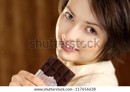 portrait of a happy beautiful woman and chocolate in his hands