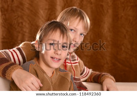 portrait of a beautiful happy brothers posing on a brown background