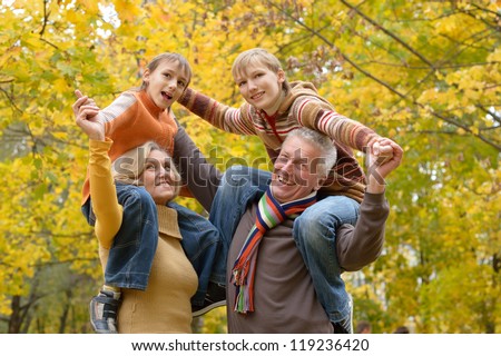 portrait of happy beautiful elderly couple and grandchildren rest fall