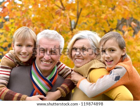 portrait of happy beautiful elderly couple and grandchildren together resting