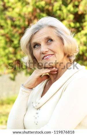 portrait of a nice old lady in the autumn park