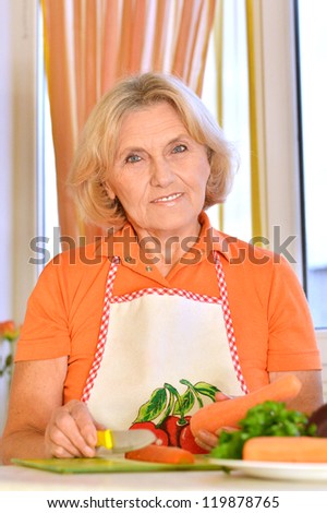 cute elderly woman preparing food in the kitchen