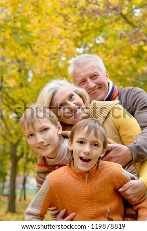 happy elderly couple and boys resting in autumn