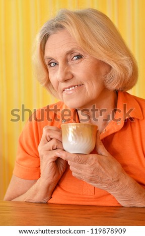 woman in an orange drink tea