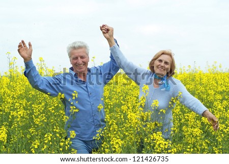 beautiful elderly couple posing against the sky