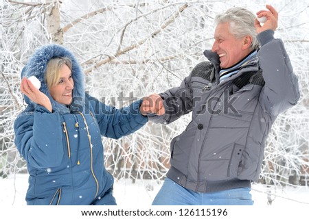 Happy elderly couple in warm clothes in winter outdoors