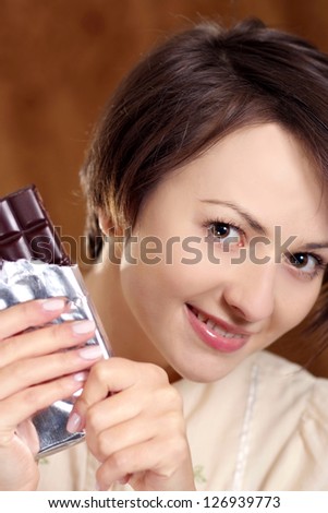 portrait of a happy beautiful woman and chocolate in his hands
