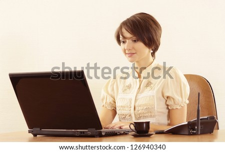 Portrait of a nice young girl with a laptop