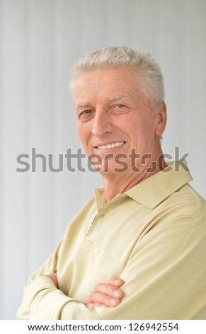 cute older man poses in a room
