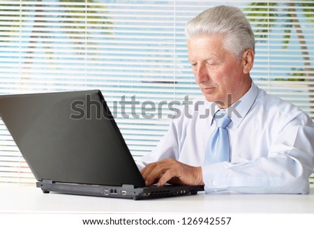 man sitting at the laptop on a light background