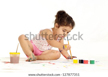 Cute little girl draws on the floor