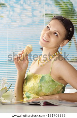 beautiful young woman eating ice-cream and enjoy your holiday