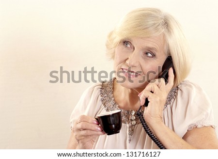 Portrait of a beautiful Mature Woman speaking on the phone
