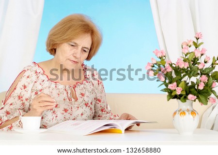 Beautiful older woman resting in the bedroom after a hard working week