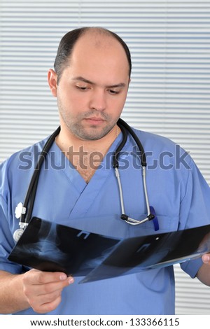 Studio portrait of a doctor in blue uniform  over texture background