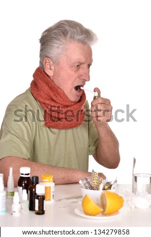 elderly caucasian man treated by medicines on a white background
