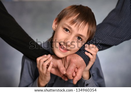 little boy joins hands with grandparents