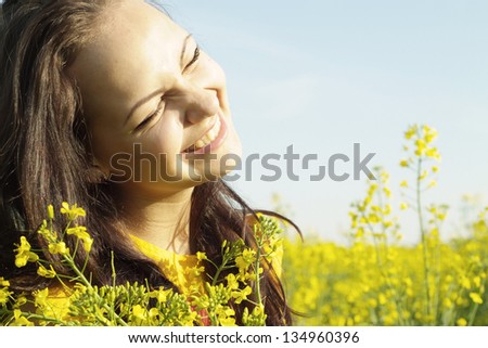Cool young girl in the middle of a field of yellow flowers