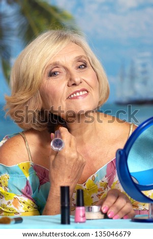 beautiful portrait of an older woman making up