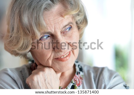 close-up portrait of a happy older woman in studio