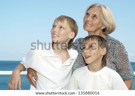 Portrait of an elderly woman with two grandchildren on a summer holiday