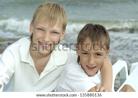 portrait of two brothers smiling on the background of the sea