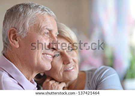 close-up portrait of a happy senior couple at home