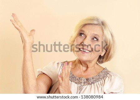 older woman showing your product on a light background