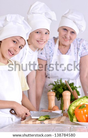 Grandmother with grandchildren preparing dinner for the whole family